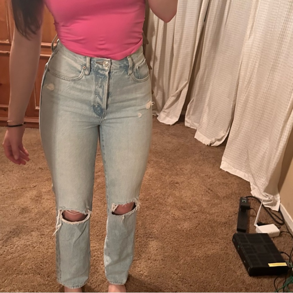 Pink Top and Light Blue Ripped Jeans